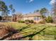 Brick home with side yard and landscaping at 1629 Southpoint Ln, New London, NC 28127