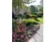 Landscaped yard with azaleas and other plants at 1629 Southpoint Ln, New London, NC 28127