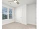 Well-lit bedroom with neutral carpet and large windows providing natural light at 1739 Dunloe St # 8242, Charlotte, NC 28206