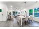 Open concept dining area with white table and chairs near the living room at 1739 Dunloe St # 8242, Charlotte, NC 28206