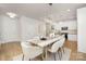 Dining room featuring modern light fixture, wood floors, and open layout to the kitchen area at 1739 Dunloe St # 8242, Charlotte, NC 28206