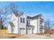 Stunning white home featuring a two-car garage, impeccable design, and modern architectural elements at 1739 Dunloe St # 8242, Charlotte, NC 28206