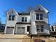 Two-story white house with a two car garage and landscaped yard at 1739 Dunloe St # 8242, Charlotte, NC 28206