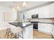 Modern kitchen featuring a center island with seating, stainless steel appliances, and white cabinetry at 1739 Dunloe St # 8242, Charlotte, NC 28206