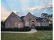 Brick home with landscaped yard and walkway at 210 Classic Ct, Mount Holly, NC 28120