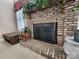 Black fireplace doors and brick surround at 210 Classic Ct, Mount Holly, NC 28120