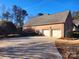 Two-car garage with a long driveway at 210 Classic Ct, Mount Holly, NC 28120