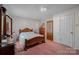 Spacious bedroom with a wooden bed frame and pink carpet at 2356 Ben Yount Ln, Vale, NC 28168