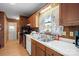 View of kitchen, showcasing wood cabinets, stove, and a sink at 2356 Ben Yount Ln, Vale, NC 28168