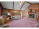 Vaulted ceiling living room with wood paneling and brick fireplace at 2356 Ben Yount Ln, Vale, NC 28168