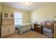 Small bedroom with twin bed, storage, and built-in shelving at 2519 Early Flight Dr, Charlotte, NC 28262