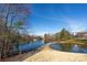 Peaceful community pond with walking path and fountain at 2519 Early Flight Dr, Charlotte, NC 28262