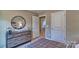 Stylish bedroom with round mirror and grey dresser at 3032 Ora Smith Rd, Lincolnton, NC 28092