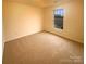 Cozy carpeted bedroom with large window and ample natural light at 310 Ann Baker Ct, Charlotte, NC 28217