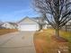 Two-story house with attached garage and a well-maintained lawn at 310 Ann Baker Ct, Charlotte, NC 28217