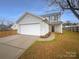 Two-story house with attached garage and a well-maintained lawn at 310 Ann Baker Ct, Charlotte, NC 28217