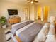 Virtually staged main bedroom with large bed and en-suite bathroom at 310 Ann Baker Ct, Charlotte, NC 28217