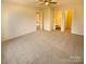 Spacious main bedroom with plush carpeting and access to bathroom at 310 Ann Baker Ct, Charlotte, NC 28217