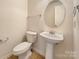 Clean bathroom featuring pedestal sink and oval mirror at 3418 Pikes Peak Dr, Gastonia, NC 28052