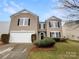 Two-story house with a tan exterior and a two car garage at 3418 Pikes Peak Dr, Gastonia, NC 28052