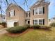 Two-story house with a tan exterior and a two car garage at 3418 Pikes Peak Dr, Gastonia, NC 28052