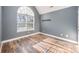 Well-lit bedroom featuring hardwood floors, a large window, and neutral walls at 346 Almora Loop, Mooresville, NC 28115