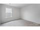 Well-lit bedroom featuring carpet and window at 3490 Buck Ct, Gastonia, NC 28056