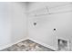 Bright laundry room with tile flooring and shelving at 3490 Buck Ct, Gastonia, NC 28056