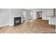 Open living room with a fireplace and wood-look flooring at 3490 Buck Ct, Gastonia, NC 28056