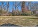 Generous grassy backyard featuring mature trees offering shade at 4017 Leeds Dr, Charlotte, NC 28205