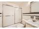 Bright bathroom with a shower-tub combo, white tile, and a classic sink and vanity at 4017 Leeds Dr, Charlotte, NC 28205