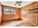 Wood-paneled bedroom with hardwood floors, natural light, and open shelving on the paneled walls at 4017 Leeds Dr, Charlotte, NC 28205