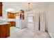 Kitchen featuring wood cabinets, white appliances, and adjacent dining area at 4017 Leeds Dr, Charlotte, NC 28205