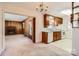 Combination kitchen and dining area with wood cabinets and white appliances at 4017 Leeds Dr, Charlotte, NC 28205