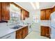 Efficient kitchen with wood cabinets and stainless steel sink at 4017 Leeds Dr, Charlotte, NC 28205