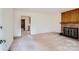 Spacious living room featuring a stone fireplace and neutral carpeting at 4017 Leeds Dr, Charlotte, NC 28205