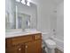 Clean bathroom with wood vanity, bathtub and shower at 41071 Calla Lily St, Fort Mill, SC 29707