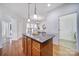 Kitchen island with granite countertop and hardwood floors at 41071 Calla Lily St, Fort Mill, SC 29707