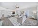 Open living room with a view into the kitchen and access to sunroom at 41071 Calla Lily St, Fort Mill, SC 29707