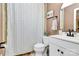 Cozy bathroom featuring shower/tub combination, tiled walls, vanity and framed mirror at 4321 Gillespie Ct, Charlotte, NC 28205