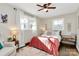 Cozy bedroom featuring a ceiling fan, windows, and a comfortable armchair at 4321 Gillespie Ct, Charlotte, NC 28205