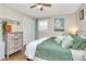 Cozy bedroom features ceiling fan, closet space, bedside table and a large window at 4321 Gillespie Ct, Charlotte, NC 28205