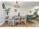 Dining room featuring a rustic table, hardwood floors, and natural lighting at 4321 Gillespie Ct, Charlotte, NC 28205