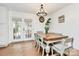 Dining room features a unique light fixture and french doors to backyard and hardwood floors at 4321 Gillespie Ct, Charlotte, NC 28205