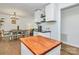 Kitchen area with butcher block island and view of dining room, modern decor and hardwood floors at 4321 Gillespie Ct, Charlotte, NC 28205