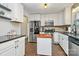 Well-lit kitchen with white cabinets, stainless steel appliances and butcher block island at 4321 Gillespie Ct, Charlotte, NC 28205