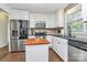 Bright kitchen featuring stainless steel appliances, white cabinets, black countertops and stainless steel dishwasher at 4321 Gillespie Ct, Charlotte, NC 28205