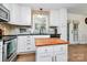 Well-lit kitchen features white cabinets, stainless steel dishwasher and a butcher block island with storage at 4321 Gillespie Ct, Charlotte, NC 28205