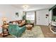 Inviting living room featuring a brown sofa, an area rug, and natural lighting at 4321 Gillespie Ct, Charlotte, NC 28205