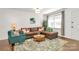 Inviting living room featuring a brown sofa, an area rug, and natural lighting at 4321 Gillespie Ct, Charlotte, NC 28205